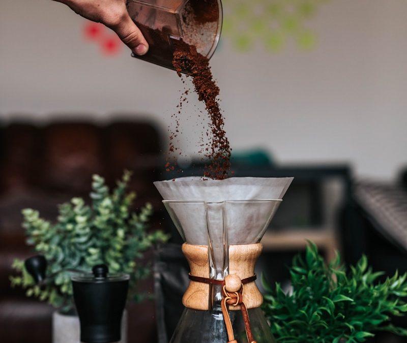 Liquid coffee fertilizer being poured into a plant pot