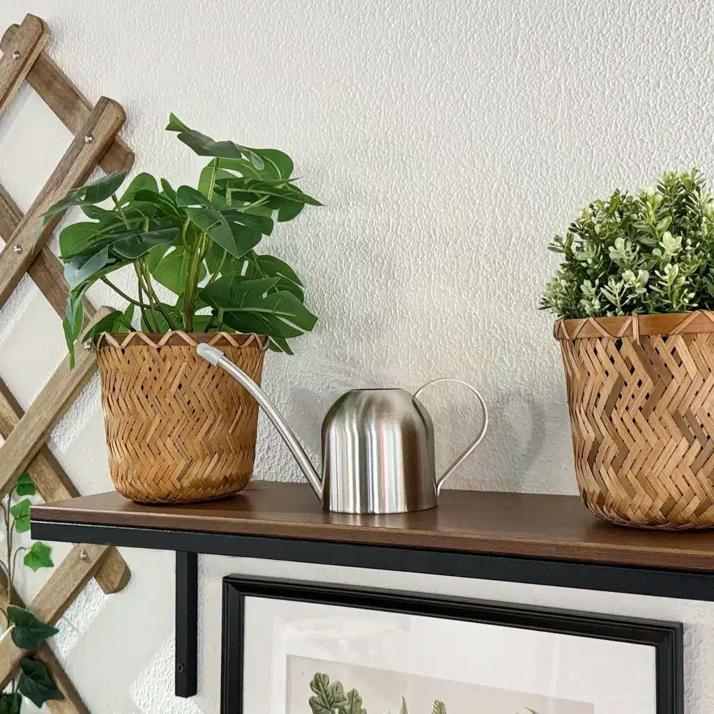 small indoor gardening setup with compact tools beside herbs and houseplants